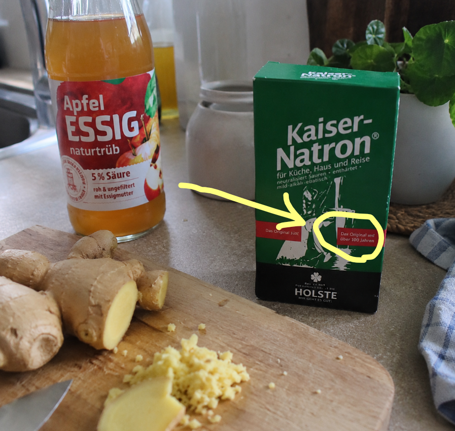 Apple cider vinegar, ginger and baking soda on a kitchen counter